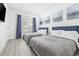 Bedroom with two beds, artwork, and large windows with curtains for a restful retreat at 2409 Seabreeze Pl., Myrtle Beach, SC 29577
