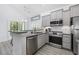 Well-equipped kitchen with stainless steel appliances, granite counters, and ample natural light at 2409 Seabreeze Pl., Myrtle Beach, SC 29577