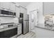 Bright kitchen with stainless steel appliances and granite countertops and stackable washer/dryer at 2409 Seabreeze Pl., Myrtle Beach, SC 29577