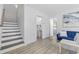 Open concept living room offering easy access to the powder room and stairs at 2409 Seabreeze Pl., Myrtle Beach, SC 29577
