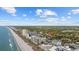 An aerial view showcases a home near Myrtle Beach and the coastline at 2602 Holly Dr., North Myrtle Beach, SC 29582