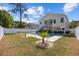Backyard pool featuring a manicured lawn, palm trees, white privacy fence and a two-story home at 2602 Holly Dr., North Myrtle Beach, SC 29582