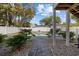 A stone walkway leading to a backyard pool with tropical landscaping and a white privacy fence at 2602 Holly Dr., North Myrtle Beach, SC 29582