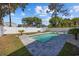 In-ground swimming pool featuring surrounding stone pavers, palm trees, landscaping and a privacy fence at 2602 Holly Dr., North Myrtle Beach, SC 29582