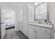 Bathroom with double vanity, white cabinets, and access to the bedroom at 2602 Holly Dr., North Myrtle Beach, SC 29582