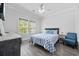 Cozy bedroom with modern decor, ceiling fan, and large window with natural light at 2602 Holly Dr., North Myrtle Beach, SC 29582