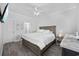 Neutral bedroom features a wood bed, neutral walls, wood-look floors and plenty of natural light at 2602 Holly Dr., North Myrtle Beach, SC 29582