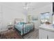 Bright bedroom features a brass bed, neutral walls, wood-look floors and plenty of natural light at 2602 Holly Dr., North Myrtle Beach, SC 29582