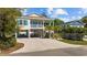 View of the exterior of the coastal home with elevated construction, spacious parking, and a welcoming front porch at 2602 Holly Dr., North Myrtle Beach, SC 29582