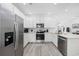 The modern kitchen features stainless steel appliances, white cabinetry, ample counter space, and wood-style flooring at 2602 Holly Dr., North Myrtle Beach, SC 29582