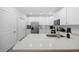 A well-lit kitchen featuring stainless steel appliances, white cabinets, quartz countertops, and ample counter space at 2602 Holly Dr., North Myrtle Beach, SC 29582