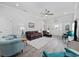 Bright living room with leather furniture, ceiling fan, and light gray wood flooring at 2602 Holly Dr., North Myrtle Beach, SC 29582