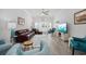 Well-lit living room featuring leather furniture, ceiling fan, and modern decor accents at 2602 Holly Dr., North Myrtle Beach, SC 29582