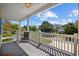 A tranquil porch setting with a wooden deck, white railing, ceiling fan, and neighborhood views at 2602 Holly Dr., North Myrtle Beach, SC 29582