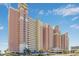 Low angle view of the exterior facade with multiple levels of balconies and resort parking at 2801 South Ocean Blvd. # 335, North Myrtle Beach, SC 29582