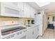 Bright kitchen features white cabinets, modern appliances, and granite countertops at 2801 South Ocean Blvd. # 335, North Myrtle Beach, SC 29582