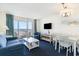 Cozy living room with comfortable seating, television, dining space, and scenic balcony access at 2801 South Ocean Blvd. # 335, North Myrtle Beach, SC 29582
