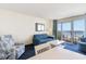 Inviting living room featuring a blue sofa, accent chair, and access to the balcony at 2801 South Ocean Blvd. # 335, North Myrtle Beach, SC 29582