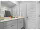 Bright, clean bathroom with white cabinets, large mirror, and tiled floors at 295 Brackish Dr. # 673, Myrtle Beach, SC 29588