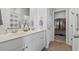 Bright bathroom featuring double sinks, white cabinets, and a closet at 295 Brackish Dr. # 673, Myrtle Beach, SC 29588