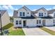 Charming townhome with white siding, inviting front yard, and private garage at 295 Brackish Dr. # 673, Myrtle Beach, SC 29588