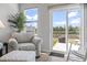 Cozy corner with armchair and view of the backyard and pond through sliding glass doors at 295 Brackish Dr. # 673, Myrtle Beach, SC 29588