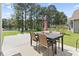 Enjoy outdoor dining with a view of the lake on the backyard patio, offering a serene and picturesque setting at 305 Blue Rock Dr., Longs, SC 29568