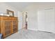 Cozy bedroom showing the closet, wood cabinet, carpet, and door leading to another room, providing functionality and comfort at 305 Blue Rock Dr., Longs, SC 29568