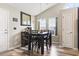 Cozy dining area with a dark wood table set, mirror accent, and natural lighting from nearby windows at 305 Blue Rock Dr., Longs, SC 29568