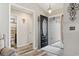 Welcoming entryway featuring modern flooring, an open door, and a glimpse of the bathroom at 305 Blue Rock Dr., Longs, SC 29568
