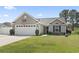 Charming single-story home featuring a well-manicured lawn and attached two-car garage at 305 Blue Rock Dr., Longs, SC 29568