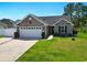 Lovely one-story home with an attached garage and attractive landscaping at 305 Blue Rock Dr., Longs, SC 29568