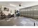 A well-organized garage with ample storage space, features rubber tile flooring, and a mounted television at 305 Blue Rock Dr., Longs, SC 29568