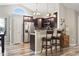 A charming kitchen featuring a breakfast bar with seating, modern appliances, and warm lighting at 305 Blue Rock Dr., Longs, SC 29568
