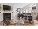 Inviting living space with a fireplace, modern flooring, a dining area, and comfortable seating at 305 Blue Rock Dr., Longs, SC 29568