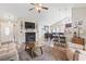 Bright and airy living area with a fireplace, dining space, kitchen bar, and comfortable sofa at 305 Blue Rock Dr., Longs, SC 29568