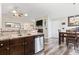 Open living space with a kitchen, dining area, stainless steel appliances, and modern flooring at 305 Blue Rock Dr., Longs, SC 29568