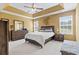 Spacious main bedroom with tray ceiling, two windows, ceiling fan, and a king size bed making it comfortable at 305 Blue Rock Dr., Longs, SC 29568