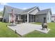 Spacious patio with an outdoor dining set and a fire pit, ideal for entertaining guests and enjoying the backyard at 305 Blue Rock Dr., Longs, SC 29568