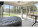 Relax on the screened-in porch, providing an inviting space with views of the trees and outdoor patio area at 305 Blue Rock Dr., Longs, SC 29568