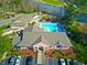 Aerial view of community center with swimming pool and manicured landscaping at 321 Heather Ct., Sunset Beach, NC 28468