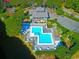 Aerial view of a resort style pool and decking, with lush trees and landscaping at 321 Heather Ct., Sunset Beach, NC 28468