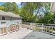 Back deck leading to a yard surrounded by trees, offering a private outdoor retreat at 321 Heather Ct., Sunset Beach, NC 28468
