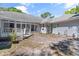 Charming backyard with a screened porch, light-blue siding, and inviting outdoor space at 321 Heather Ct., Sunset Beach, NC 28468