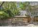 Private backyard with mature trees and a wooden fence at 321 Heather Ct., Sunset Beach, NC 28468