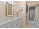 Cozy bathroom featuring a white vanity with a large mirror and shower-tub combo at 321 Heather Ct., Sunset Beach, NC 28468