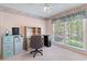 Charming bedroom with a large window, a built-in desk, and neutral carpet at 321 Heather Ct., Sunset Beach, NC 28468