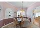 Cozy dining area with glass-topped table and arched doorways providing an open feel at 321 Heather Ct., Sunset Beach, NC 28468