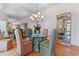 Elegant dining room with a glass table, upholstered chairs, mirrored walls, and wood flooring at 321 Heather Ct., Sunset Beach, NC 28468