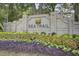 Community entrance sign surrounded by colorful flowers and lush greenery at 321 Heather Ct., Sunset Beach, NC 28468